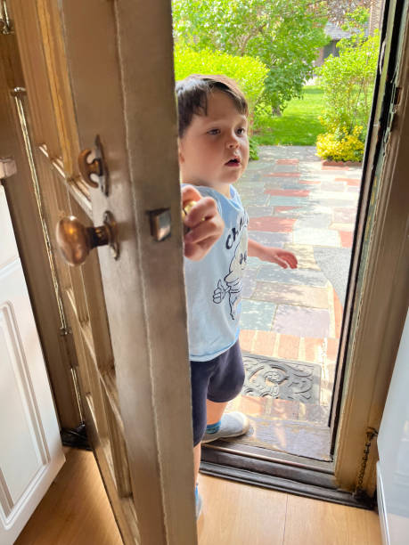 istock Toddler standing by door 1825826163