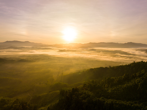 Aerial view colorful sky over mountains tropical rainforest,Bird eye view image over the fog, Amazing nature background with clouds and mountain peaks in Thailand