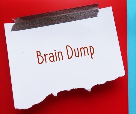 Stick note on red background written Brain Dump -  unload or get your thoughts on paper and free up space in your brain