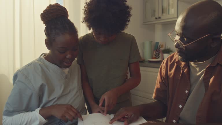 Black Female Health Worker Spending Time with Family at Home