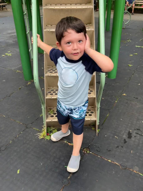 istock Boy standing by stairs at playground 1825894128