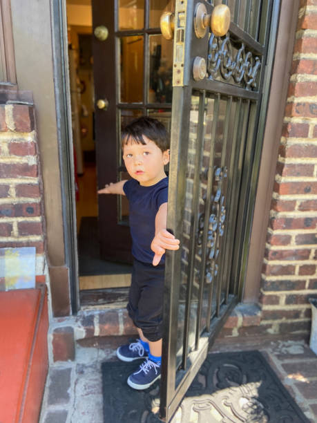 istock Little boy standing by door 1825895056