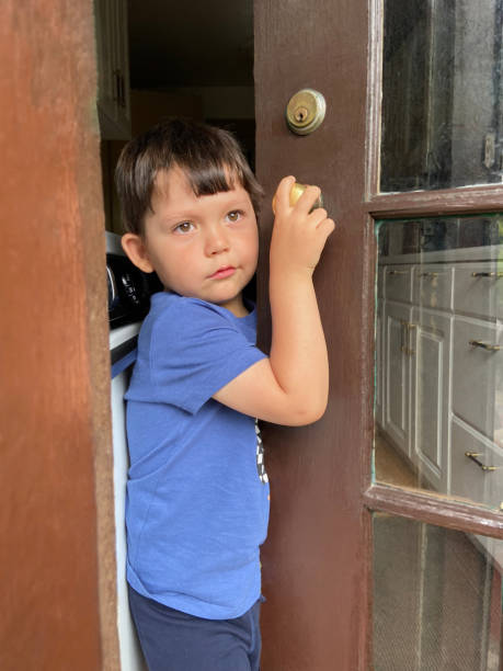 istock Little boy holding the door 1825895535