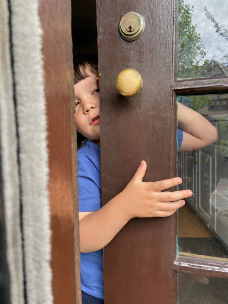 istock Little boy holding the door 1825895550