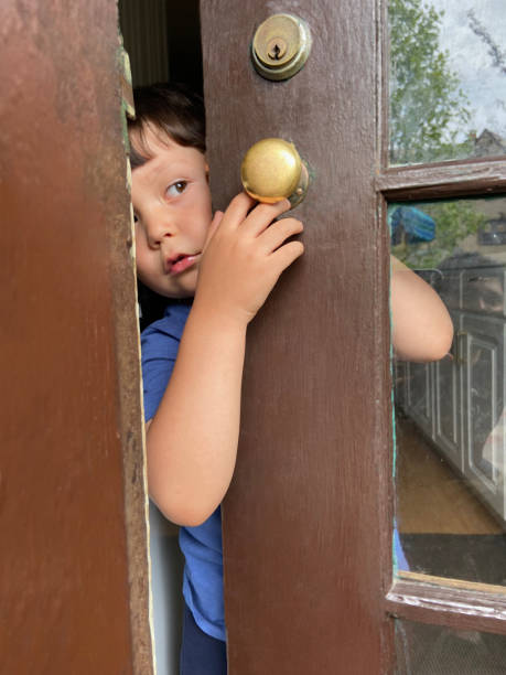istock Little boy holding the door 1825895839