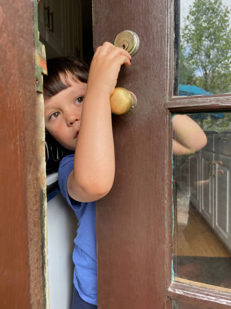 istock Little boy holding the door 1825896071