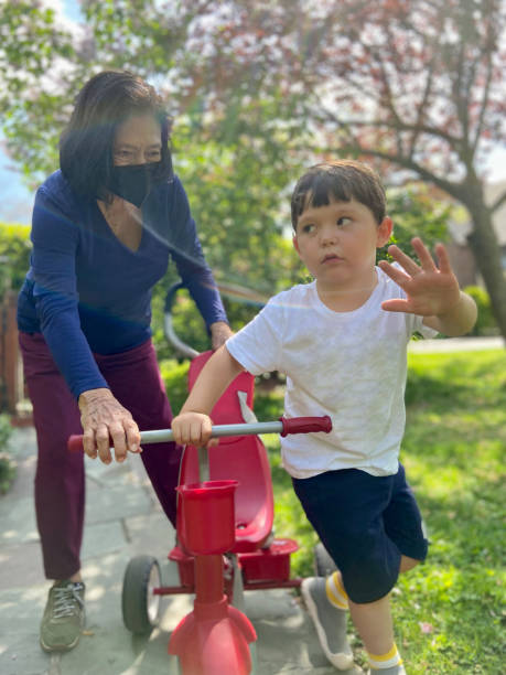 istock Little boy riding a tricycle 1825897637