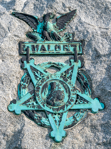 Spanish-American War Medal of Honor for Valor grave marker on granite headstone.