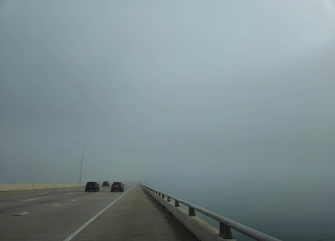 Cars Driving Into Fog On Bridge In Galveston Texas