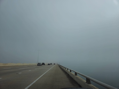 Cars Driving Into Fog On Bridge In Galveston Texas