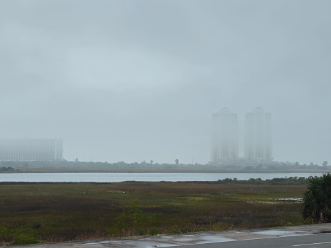 Cloudy Sky and Low Clouds Surrounding Towers Buildings
