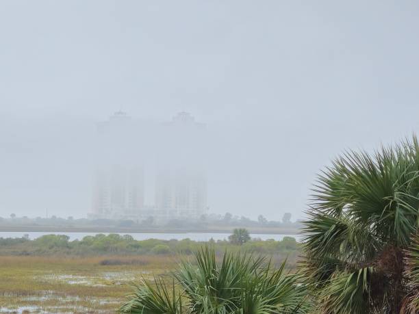 istock Cloudy Sky and Low Clouds Surrounding Towers Buildings 1825928977