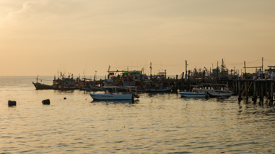 Samaesan Sattahip Chonburi Thailand 30 November 2023, Thai fishing boat on a wooden pier during sunset