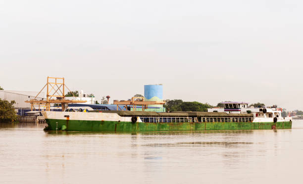 istock Cargo ship with industrial factory pier background 1825940570