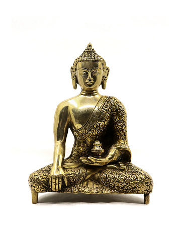 intricate golden statue of buddha meditating in peace handcrafted with beautiful and exquisite details, from a collection of luxury antique objects, isolated in a white background