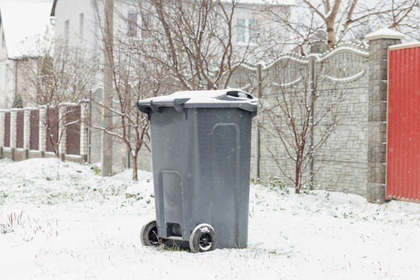 istock A trash can covered with snow next to a house. Garbage removal in winter 1825962696