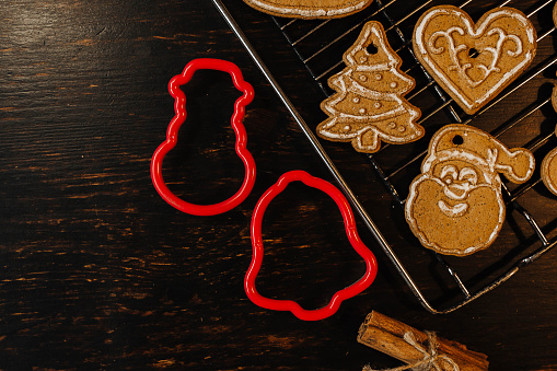 Gingerbread cookies on a wooden background. Cooking Christmas sweets.