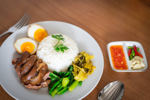 istock Stewed pork leg with boiled egg and rice on white plate. 1826074738