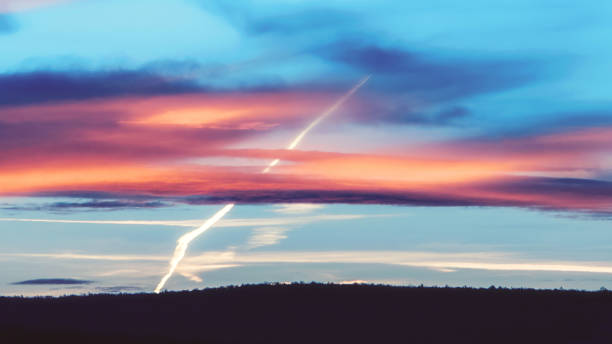Beautiful sunset cloudscape with chemtrails