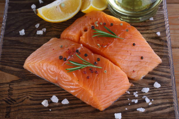 Salmon fillet on wooden background stock photo