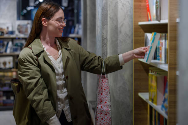 istock Journey Unfolds as She Discovers Her Book in the Bookstore 1826144824