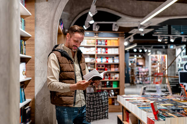 istock Man Ventures into a Bookstore, Enthralled by the Array of Choices Before Him 1826146932