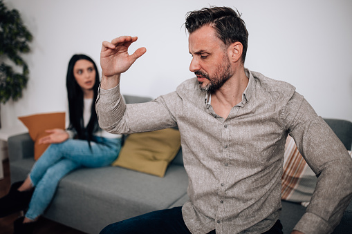A disagreement between a mid adult man and a young woman is escalating, with both parties fighting over trust issues and expressing their doubts and concerns