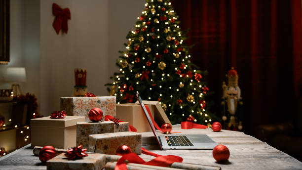 istock Desk with pc and presents under the Christmas tree 1826177353