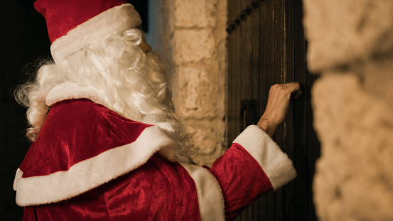 Santa Claus knocks on the door.