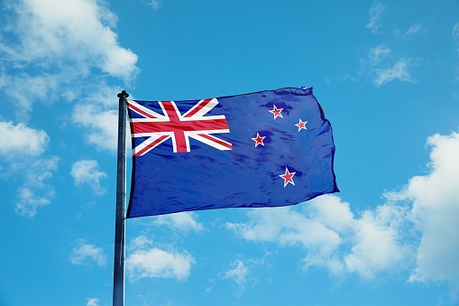 New Zealand flag waving beautifully in clear blue sky