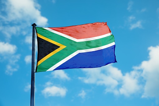 South Africa flag waving beautifully in clear blue sky