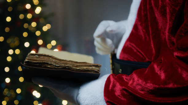 istock Santa Claus carefully reading an old wise book 1826219204