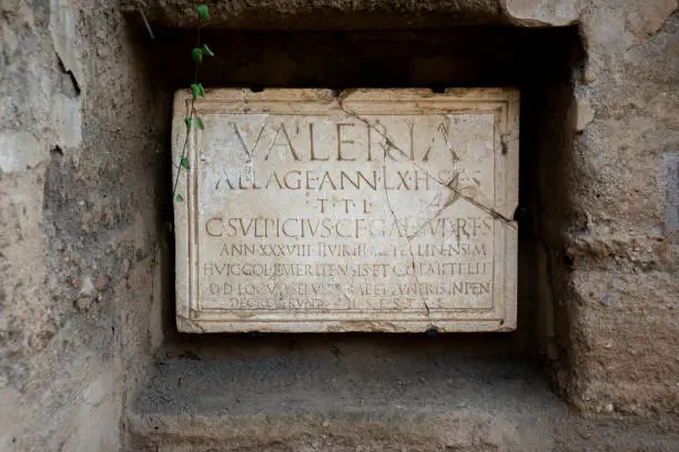 Photo of Ancient Roman inscription in marble from a funerary tombstone of Publius Valerius Laetus in Mérida Columbarios