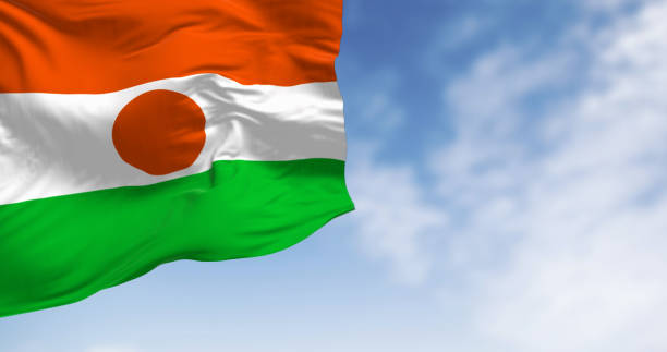 Niger national flag waving on a clear day Niger national flag waving on a clear day. Orange, white, and green stripes with orange disc in the center. 3d illustration render. Rippling fabric niger state stock pictures, royalty-free photos & images