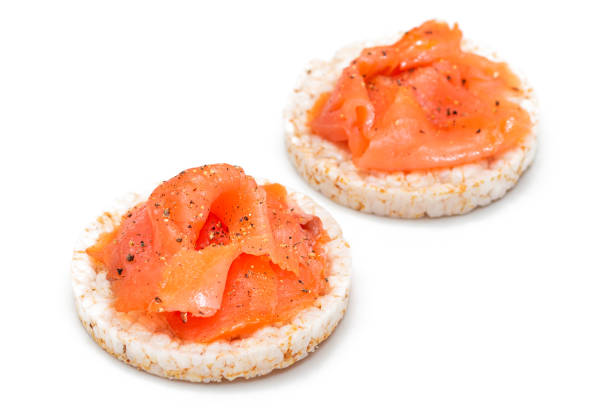 istock Rice Cake Sandwiches with Fresh Salmon Slices Isolated on White 1826284802