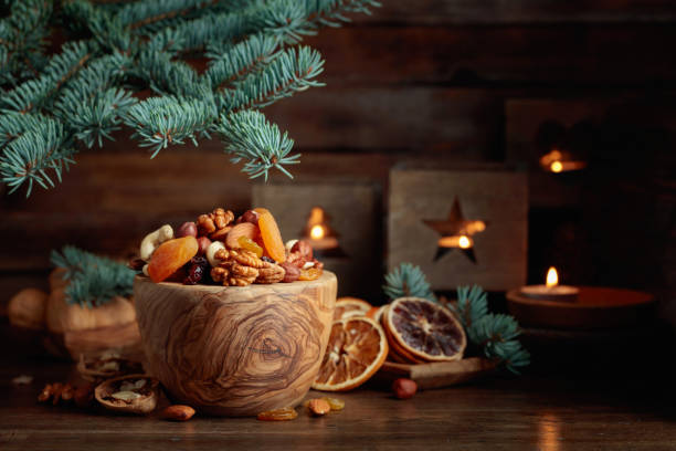 istock Dried fruits and assorted nuts on an old wooden table. 1826309867