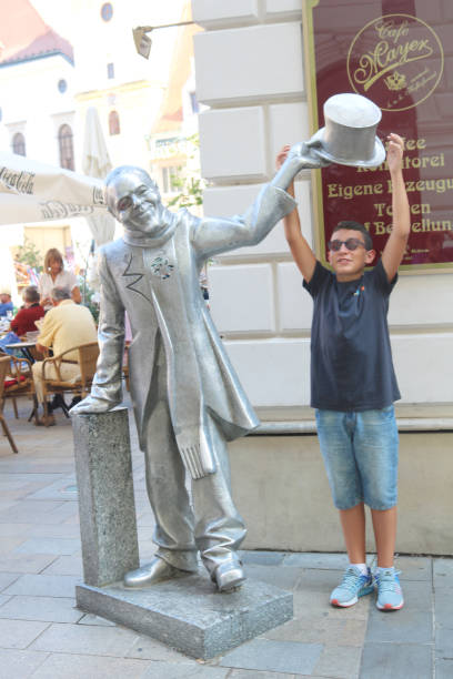 Bratislava, Slovakia - September 01, 2019: Schone Naci statue and boy in old town Main Square