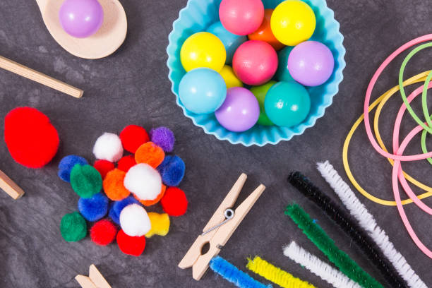 istock Colorful pompoms, balls and rubber erasers using for playing and development of kids motor skills, coordination and logical thinking 1826329548