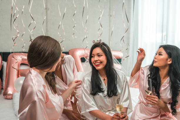 istock Hispanic Bride and Diverse Bridesmaids at Bachelorette Party Prep 1826357320