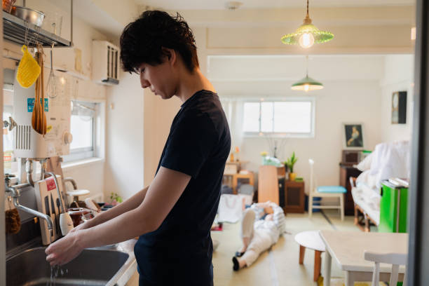 istock Husband doing housework and wife slacking off behind him 1826361218