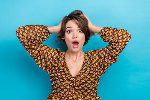 Closeup photo of staring funny woman confused hands touch hair open mouth impressed reaction messy isolated on blue color background.