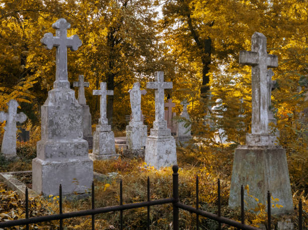 istock Autumn cemetery. Abandoned stone crosses. 1826397044
