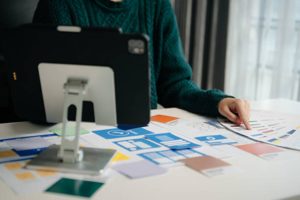 istock View of UI developer team brainstorming on their project with laptop, smartphone and digital tablet. Creative digital development agency. 1826409354