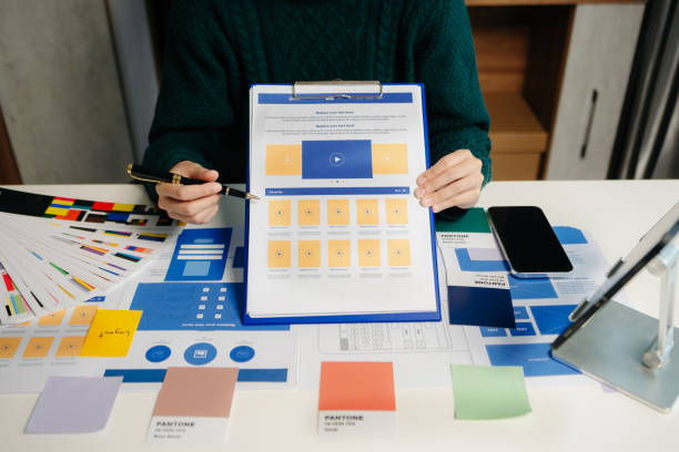istock View of UI developer team brainstorming on their project with laptop, smartphone and digital tablet. Creative digital development agency. 1826409912