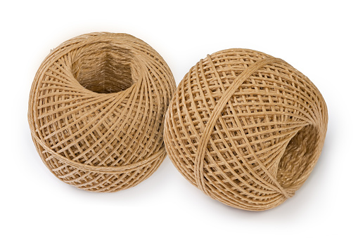 Two small skeins of the brown synthetic twine without spool on a white background