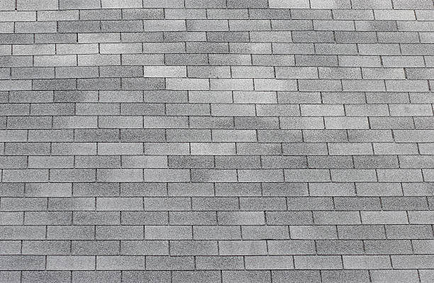 Shingles on a roof in gray and white stock photo