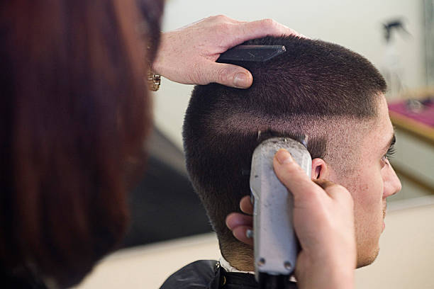 Zero Three Haircut Young man having a haircut in a salon. crew cut stock pictures, royalty-free photos & images