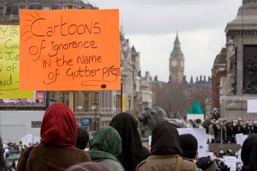 A peaceful demonstration over the Danish cartoons in London on Saturday 18 February 2006. Shot over the heads of the large crowd listening to speakers visible at the base of Nelson's Column to the right. Grey skies and Big Ben in the distance put the location in context.