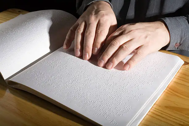 Reading a book in Braille.