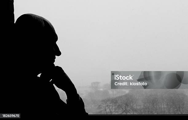 Thinking Out The Window Stock Photo - Download Image Now - In Silhouette, Senior Men, Senior Adult